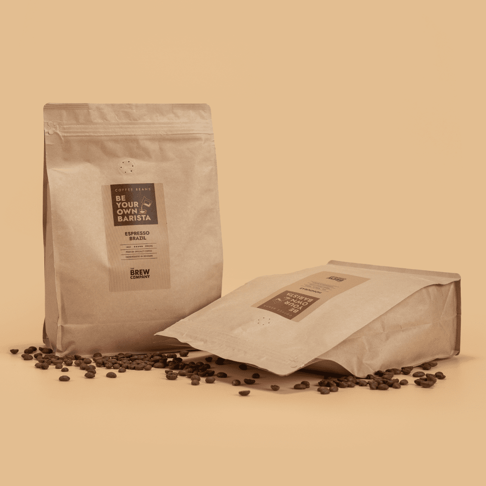 Two coffee bags with a label on a beige background - The Brew Company